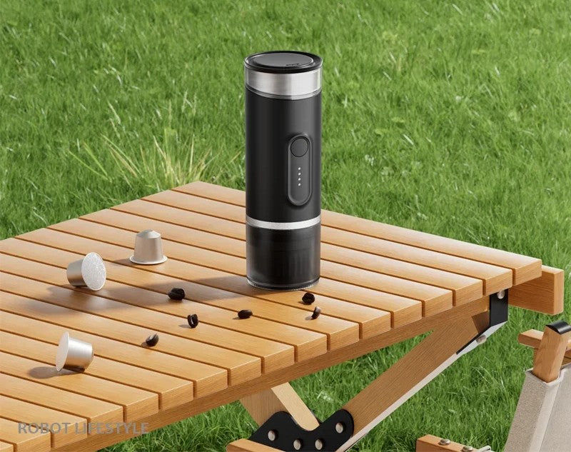 Portable coffee maker on outdoor camping table with coffee capsules - battery powered travel coffee maker for camping