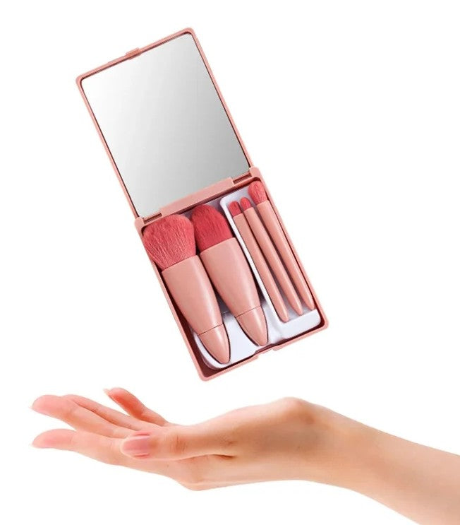 Coffee pink mini travel makeup brush set floating above hand showing compact size with mirror and 5 brushes