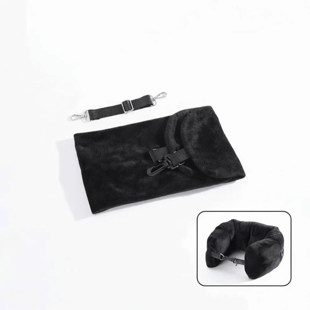 Fillable travel neck pillow in black shown flat in storage bag with adjustable shoulder strap alongside