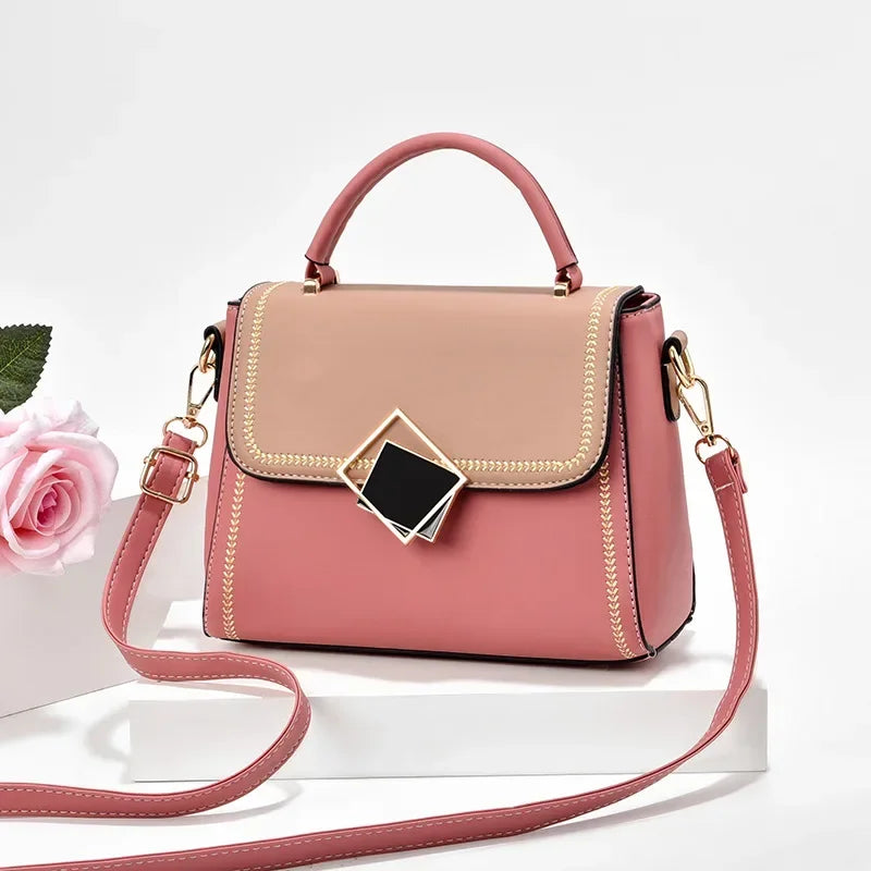 Dusty pink colour block PU leather shoulder bag with gold metal top handle and adjustable crossbody strap