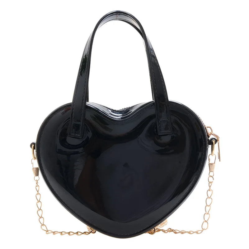 Black heart-shaped handbag front view with twin handles and gold chain strap