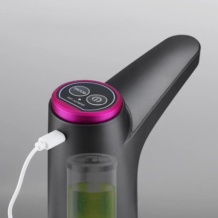 Control panel on the pump's top showing the 600 ml and power buttons, with the USB charging cable connected