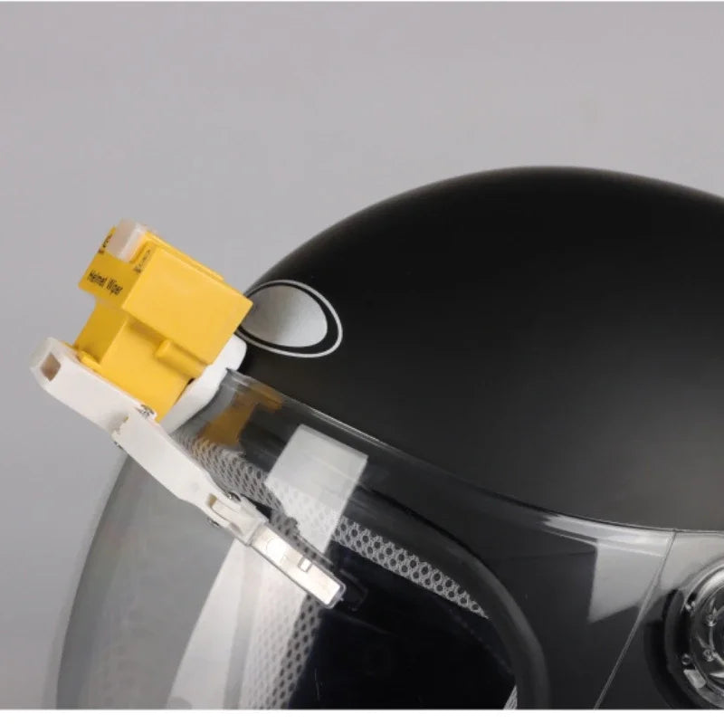 Side view of motorcycle helmet with automatic rain wiper attached to visor