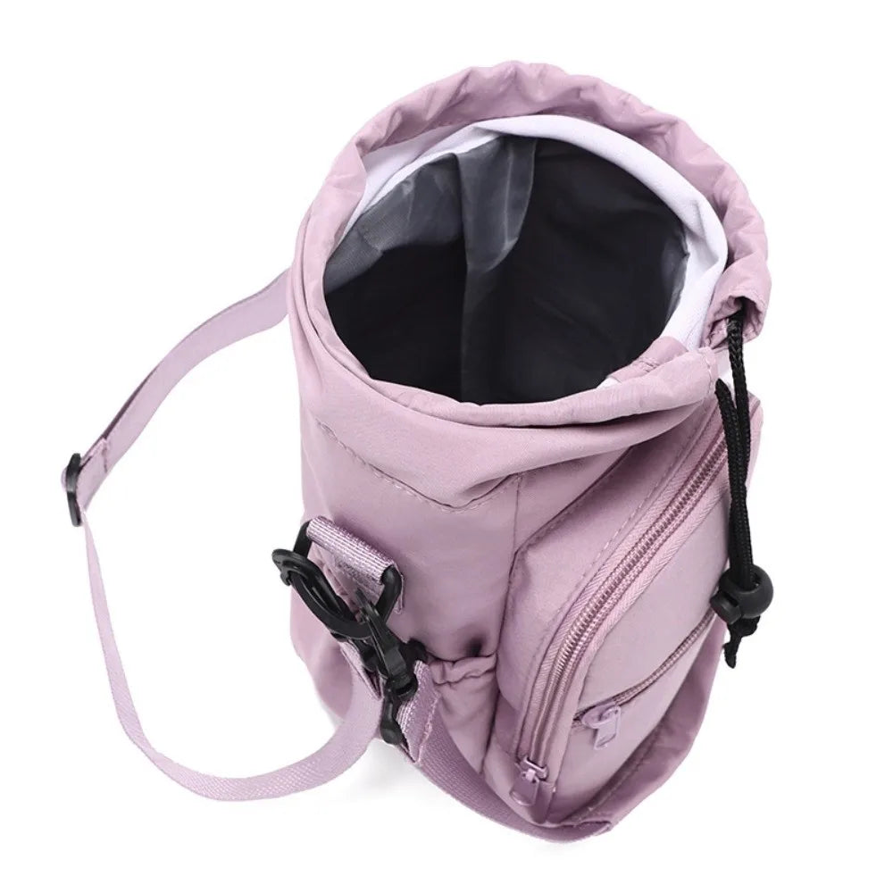Insulated water bottle bag in pink open top view showing black insulated interior lining and drawstring closure with crossbody strap and front zip pocket