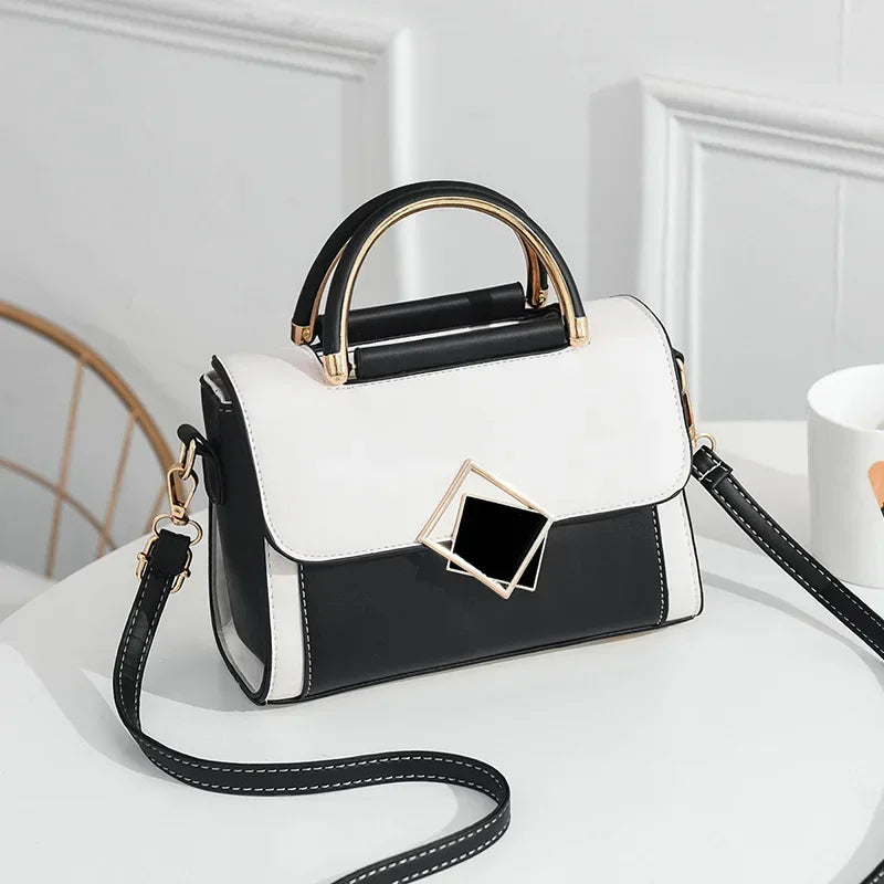 White colour block PU leather shoulder bag with gold metal top handle and adjustable crossbody strap