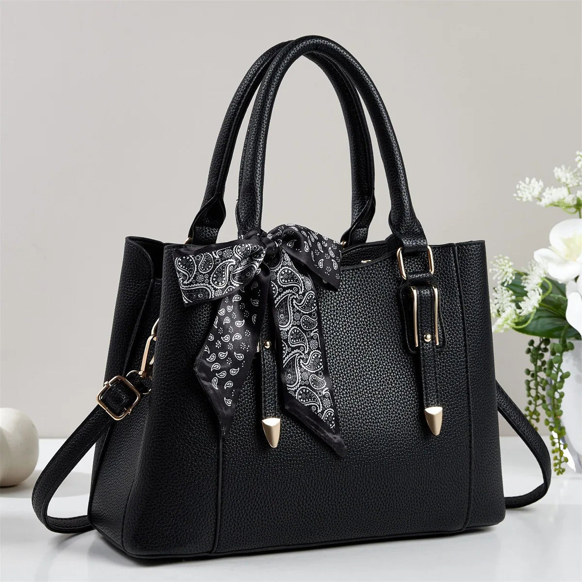 Black women's soft square shoulder bag with black paisley scarf tie detail and silver-tone hardware