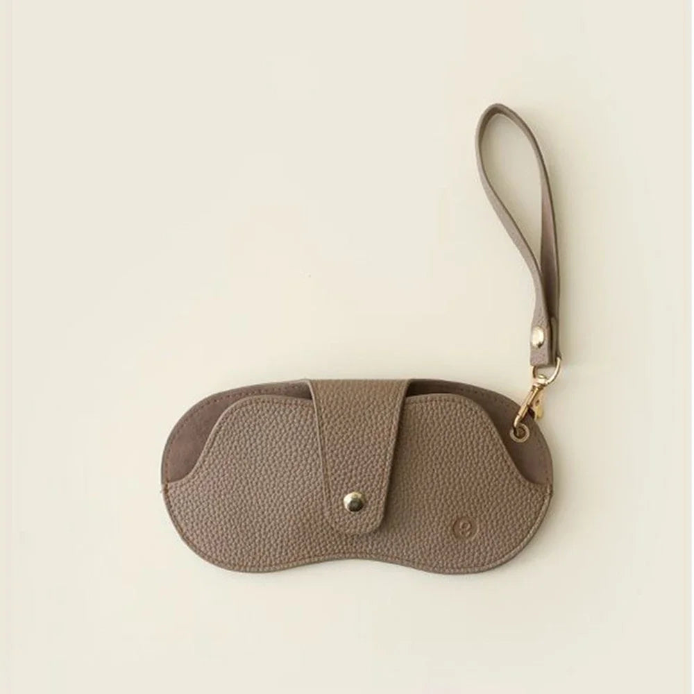 MiniSolutions oval PU leather glasses case in brown with metal snap closure and wrist strap