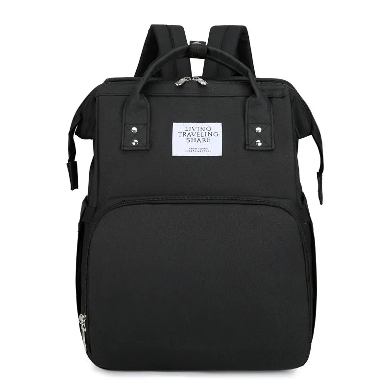 Black: 2-in-1 nappy bag backpack in black, front view