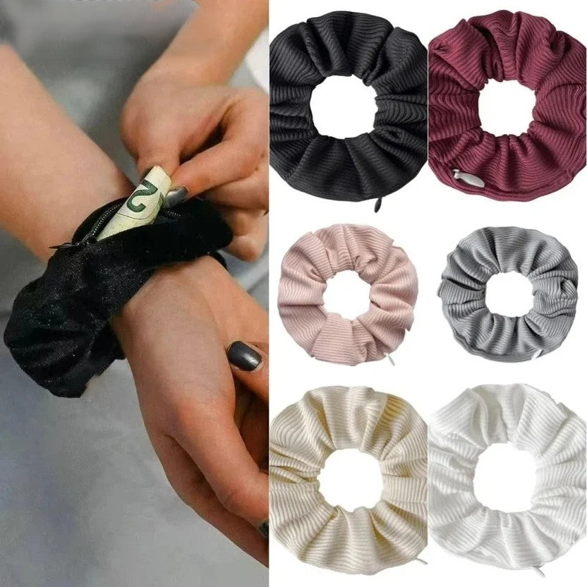Hidden closure hair scrunchie worn on wrist showing zipper pocket open with cash being accessed outdoors all six ribbed knit colour options - black, burgundy, blush pink, grey, cream and white