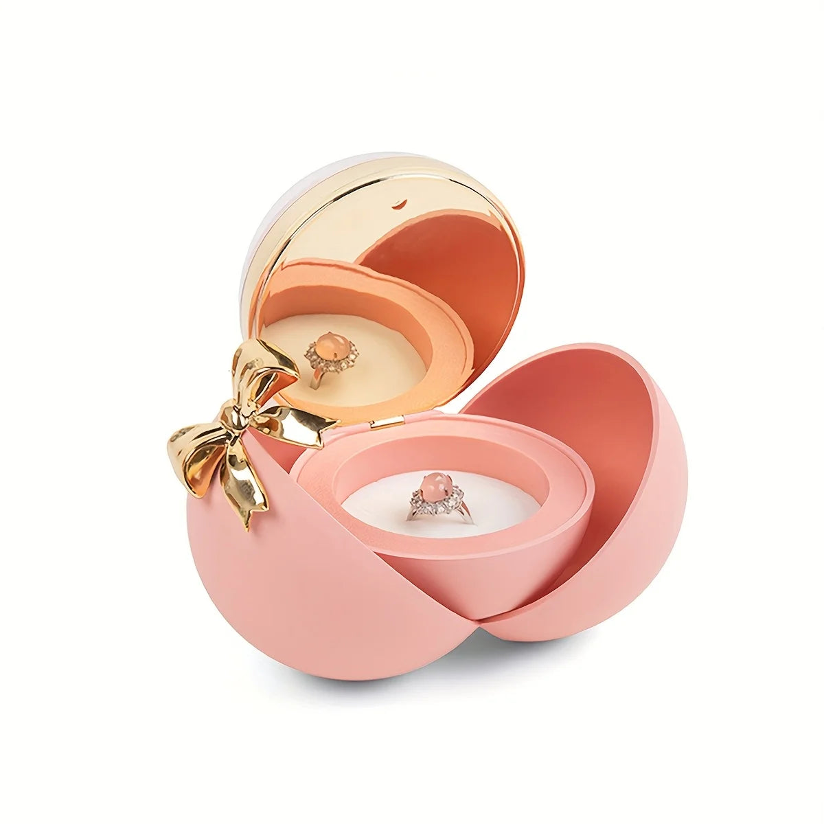 Pink ball-style jewellery box open with a pink-stone ring in the dome and a reflection of ring showing in the lid mirror