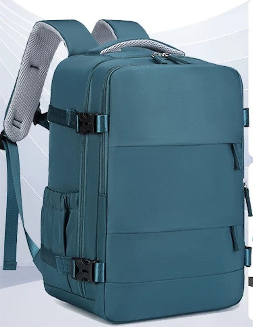 Peacock blue 30L compression travel backpack with padded mesh shoulder straps, compression buckles, and front pocket — carry-on boarding bag
