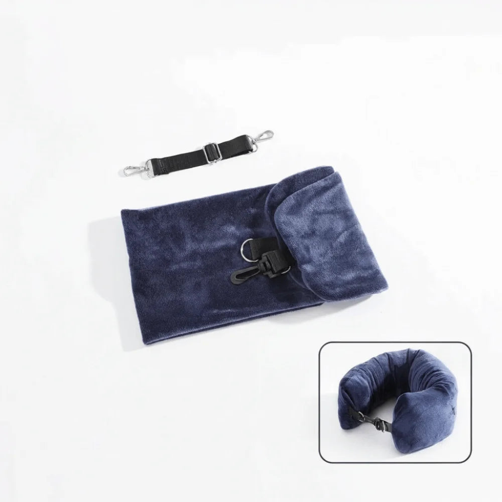 Fillable travel neck pillow in navy blue shown flat in storage bag with adjustable shoulder strap alongside