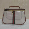 Portable Luxury Toiletry Bag in White — transparent PVC cosmetic bag with red and black stripe, front view on neutral background
