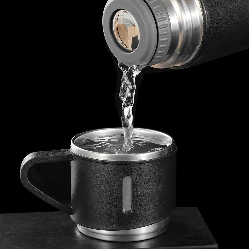 Black mug being filled with water from a thermos 