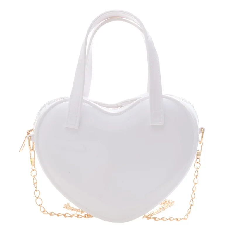 White heart-shaped handbag front view with twin handles and gold chain strap