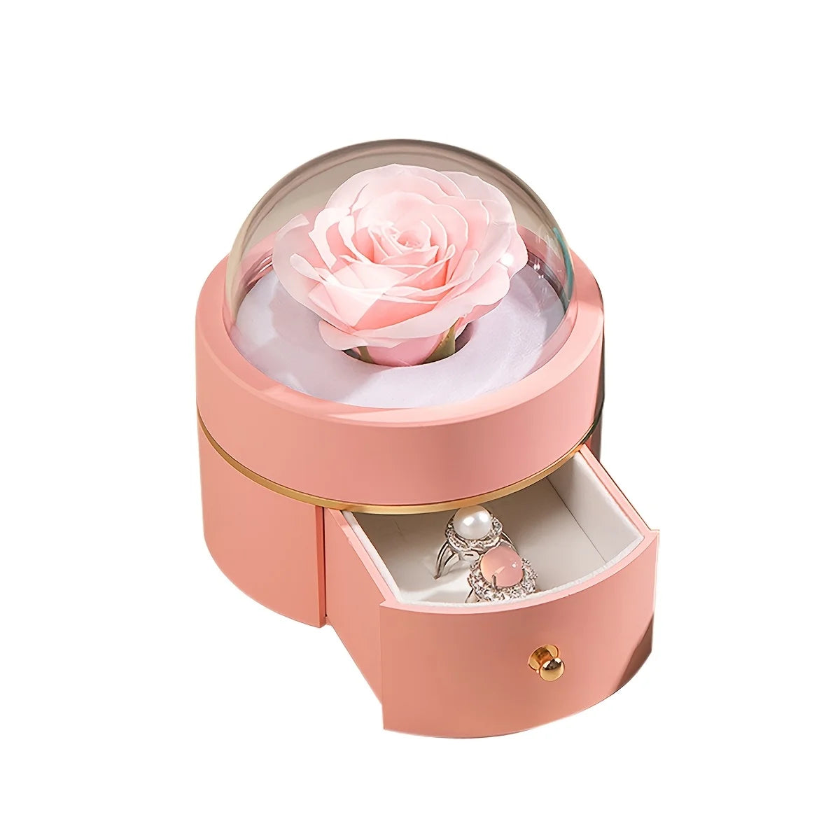 Pink round rose jewellery box with an artificial rose under a clear dome and the drawer open showing two rings 