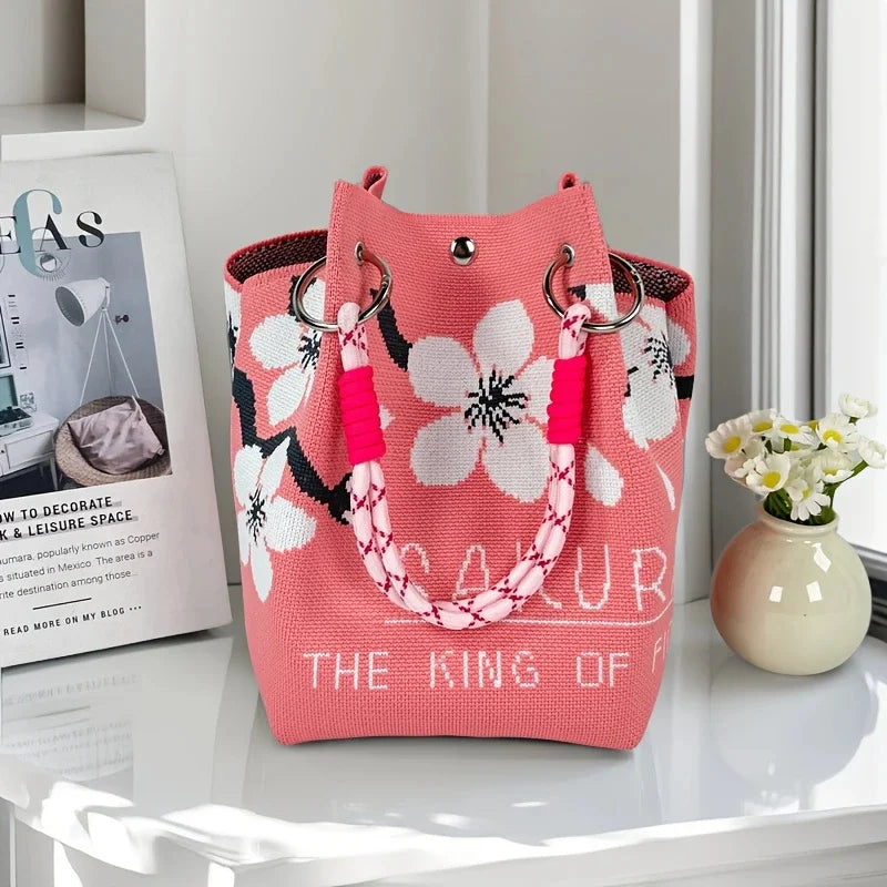 Vintage knit bucket bag in pink colour-block geometric pattern with braided rope handles