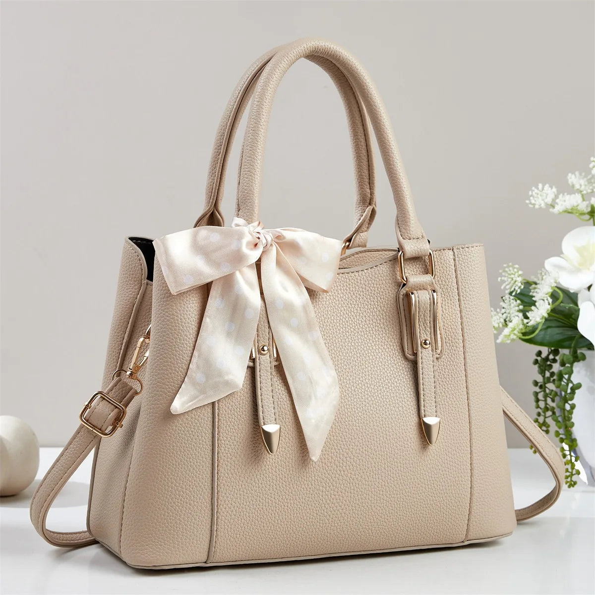 Camel women's soft square shoulder bag with paisley scarf tie detail, gold buckle hardware and crossbody strap