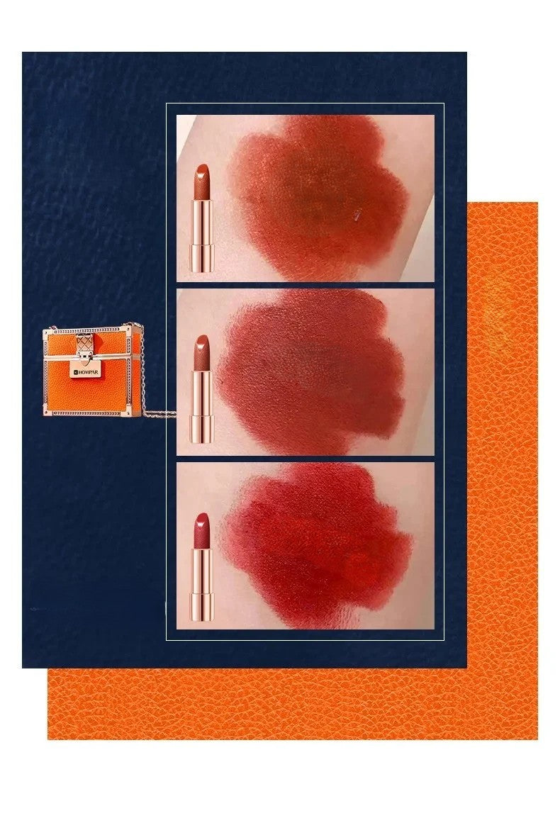 Velvet matte lipstick colour swatches — three shades shown: warm terracotta nude, deep burgundy mauve and classic red, with orange leather mini trunk bag