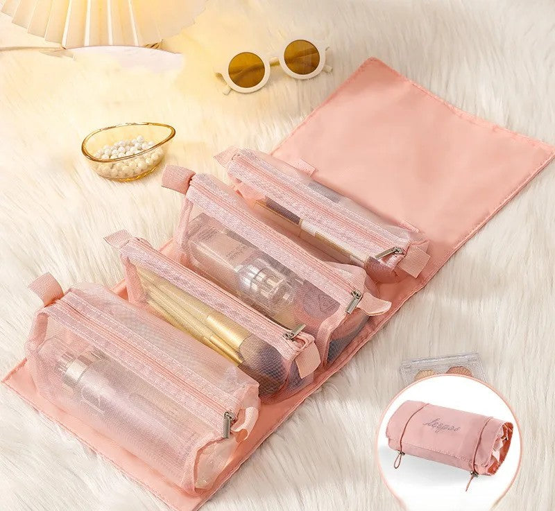 4-in-1 detachable cosmetic bag in pink unfolded showing 4 transparent zip pouches with makeup brushes and cosmetics