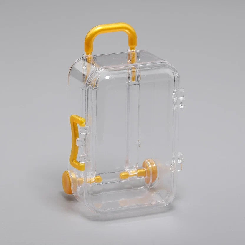 Transparent acrylic mini suitcase display box with yellow gold color-matched handle, wheels, and latch