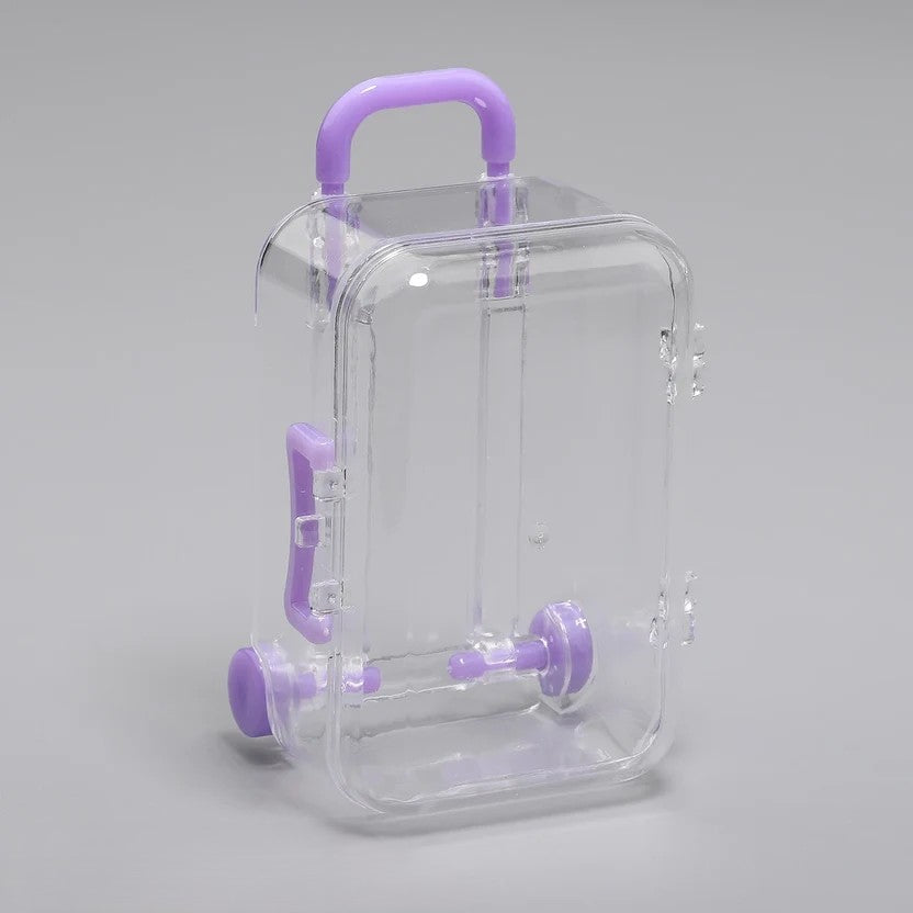 Transparent acrylic mini suitcase display box with purple color-matched handle, wheels, and latch