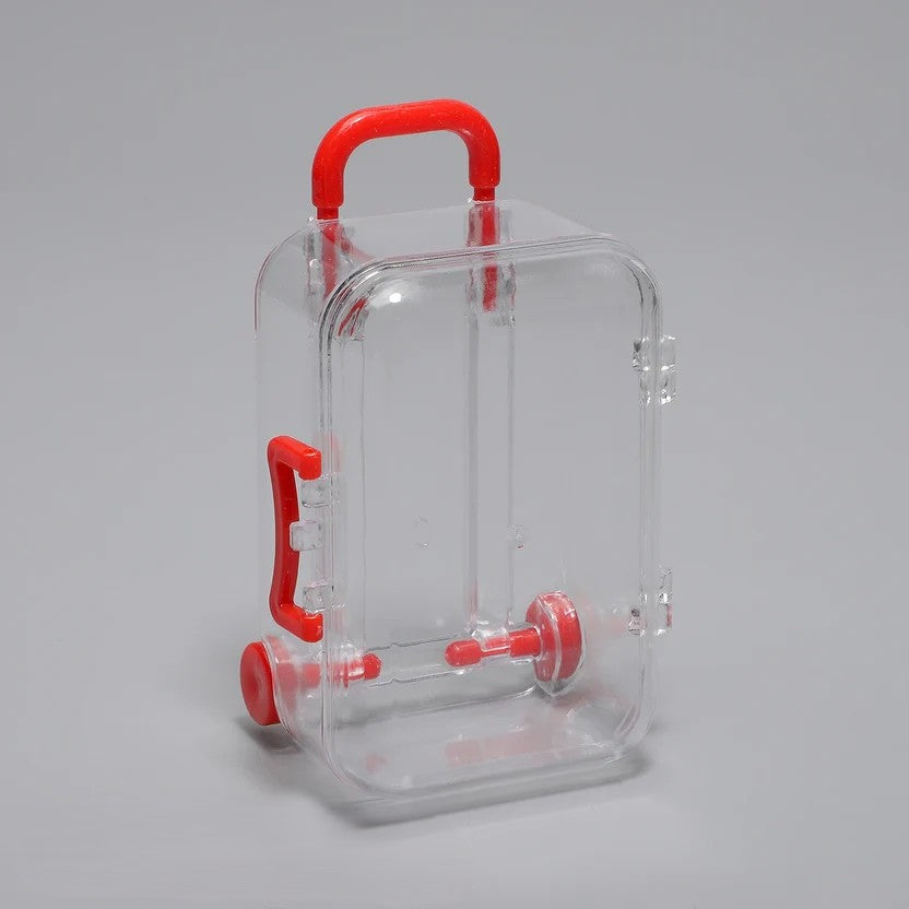 Transparent acrylic mini suitcase display box with red colour-matched handle, wheels, and latch
